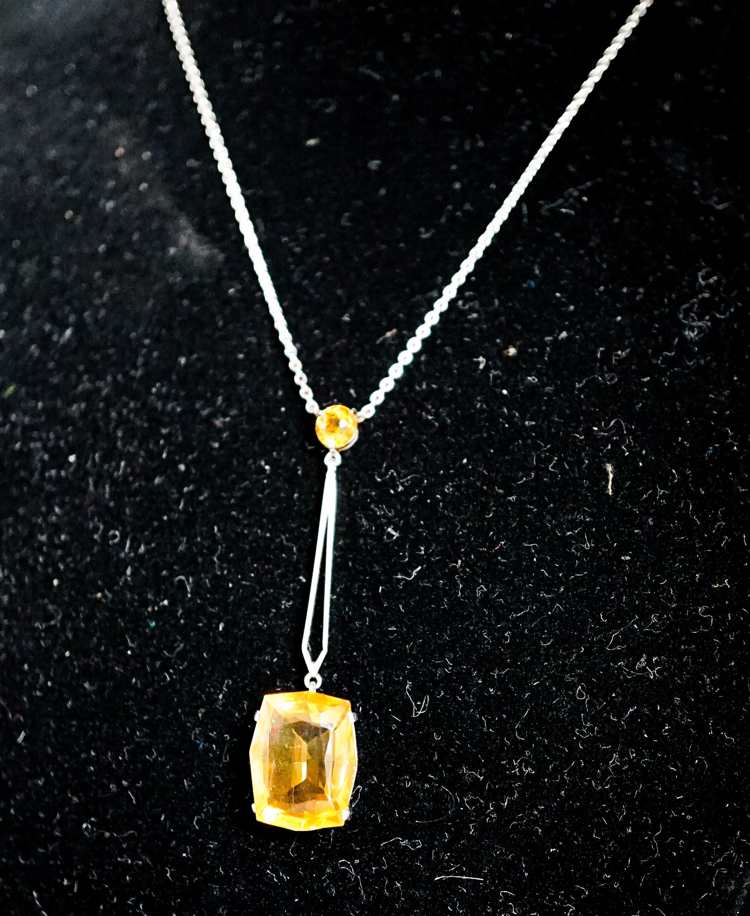 A white metal and two stone citrine set drop line pendant necklace, pendant 45mm, chain 40cm, gross weight 4.1 grams.